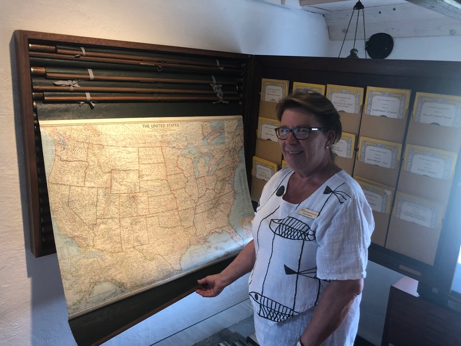 A woman unrolling a map
